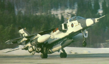  An RAF Jaguar in winter camoflage takes off carrying the large Jaguar Reconnaissance Pod